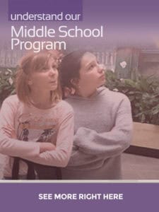 Brightly lit indoor scene featuring two young girls engaged in a Montessori middle school program at Mount Clemens, MI daycare and school, highlighting early childhood education and personalized learning environments.