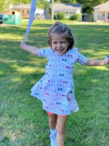 Bright young girl playing with jump rope outside at Montessori Stepping Stones daycare, cheerful children’s activity, outdoor play area in Mount Clemens, MI.