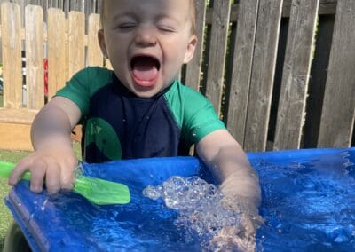 Kids playing with water table at Montessori Stepping Stones daycare in Mount Clemens, MI, promoting sensory play and outdoor learning for early childhood development.
