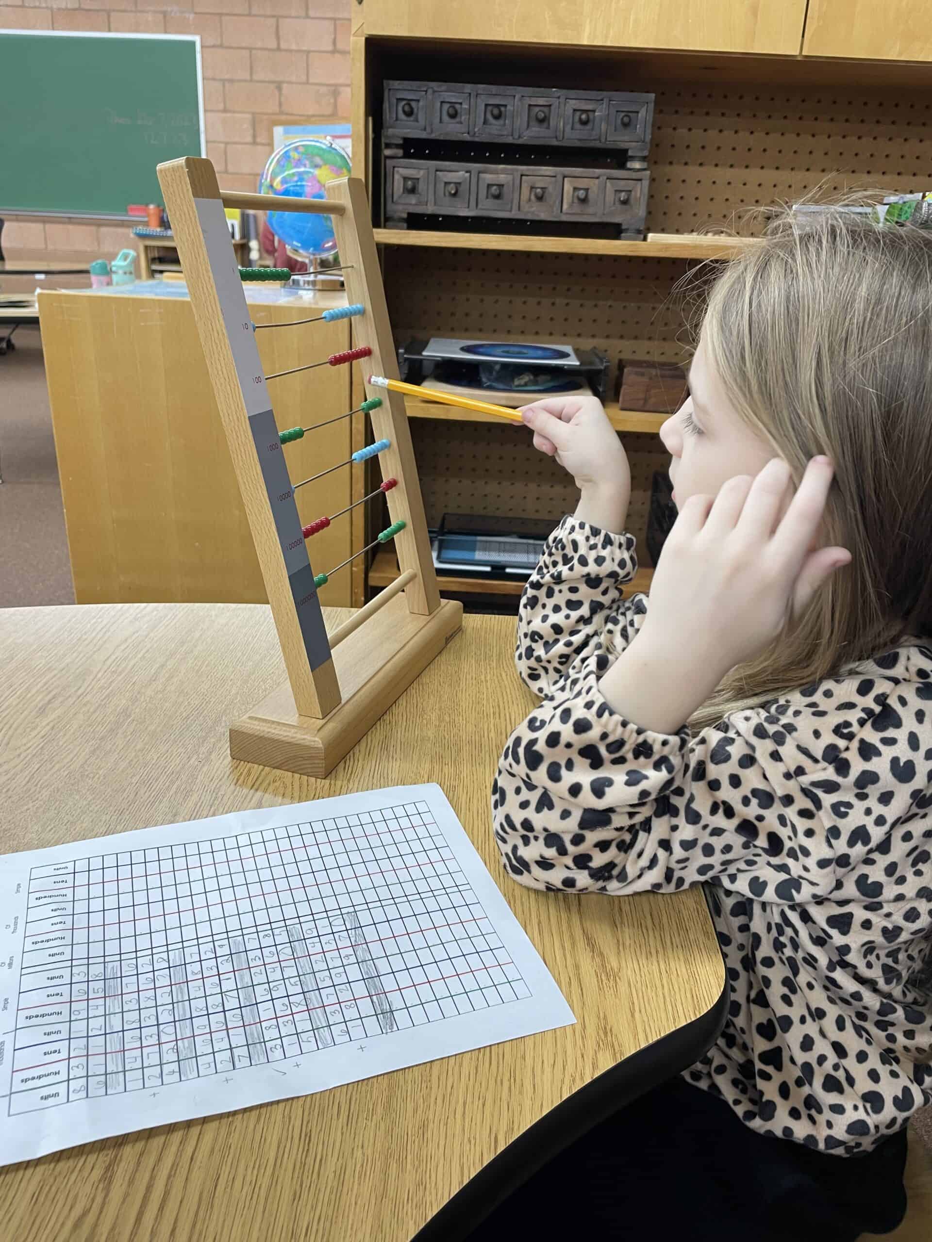 Student using math materials.