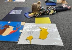 Colorful world map puzzle activity for children at Montessori Stepping Stones daycare in Mount Clemens, MI. Engaging map activities promote geography skills and early learning in a nurturing environment.