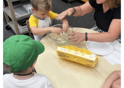 Soft-boiled eggs being cracked by a preschool boy at Montessori Stepping Stones daycare in Mount Clemens, MI.